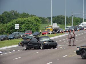 smashed car from a truck accident on the roadway