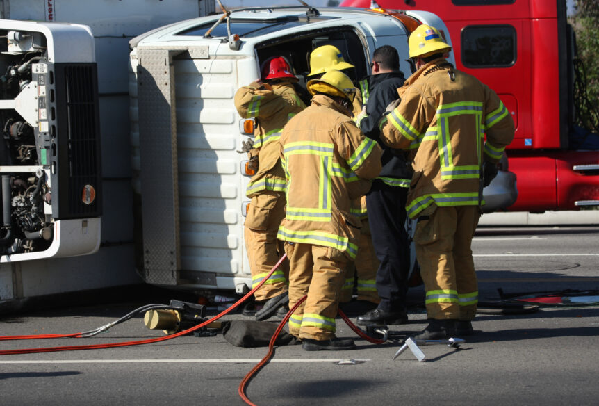 Fireman attending to a rollover truck accident.